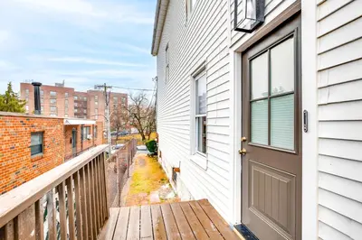 a wooden porch with a door on a building at Centrally Located and Pet Friendly Yonkers Studio! in Yonkers