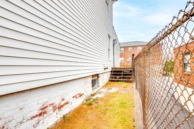 an exterior view of a building with a fence at Centrally Located and Pet Friendly Yonkers Studio! in Yonkers