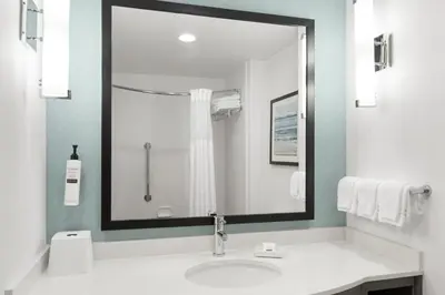 a bathroom with a sink and a large mirror at Hilton Garden Inn Lenox Pittsfield in Pittsfield