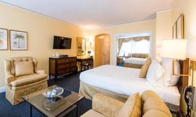 a hotel room with a large bed and a chair at 3 West Club in New York