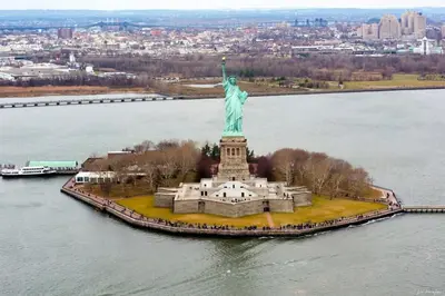 an aerial view of the statue of liberty in the water at SWJ 4 - 25 Min to Times Sq Save on 2Day Stays in New York