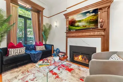 a living room with a fireplace and a tv at SWJ544FH Huge 6BR 4BA Backyard Access in New York