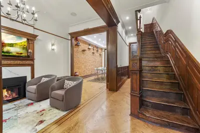 a living room with a staircase and a fireplace at SWJ544FH Huge 6BR 4BA Backyard Access in New York