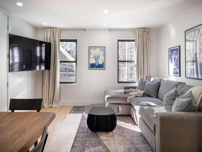 a living room with a couch and a table at Three-Bedroom Suite in Prime Williamsburg in Brooklyn