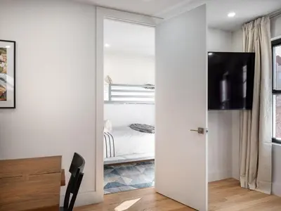 a room with a sliding door leading to a bedroom at Three-Bedroom Suite in Prime Williamsburg in Brooklyn