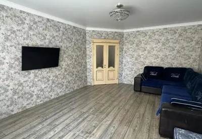 a living room with a couch and a flat screen tv at Chic and Sparkle in Beacon