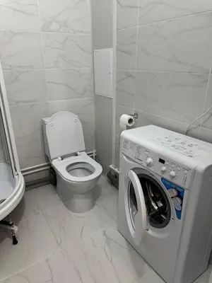 a bathroom with a toilet and a washing machine at Chic and Sparkle in Beacon