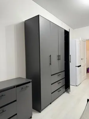 a kitchen with black and white cabinets and a refrigerator at Chic and Sparkle in Beacon