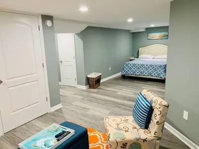 a bedroom with a bed and a couch and a chair at Semi Private cozy studio near downtown. in Montclair