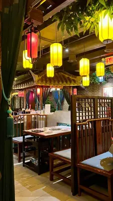 a restaurant with wooden tables and chairs and lights at Double Room in New York
