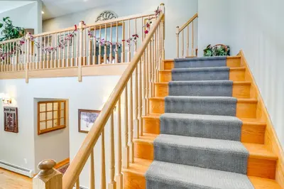 a staircase in a home with wooden railings at Less Than 1 Mi to Hunter Mtn Spacious Home with Hot Tub! in Lanesville