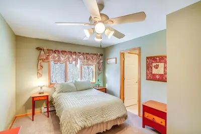 a bedroom with a bed and a ceiling fan at Less Than 1 Mi to Hunter Mtn Spacious Home with Hot Tub! in Lanesville