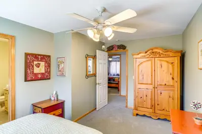 a bedroom with a bed and a ceiling fan at Less Than 1 Mi to Hunter Mtn Spacious Home with Hot Tub! in Lanesville