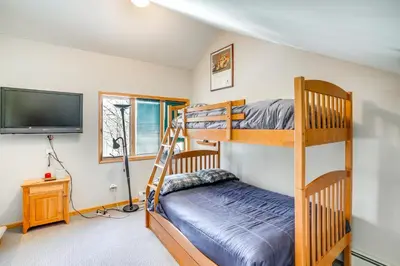 a bedroom with bunk beds and a flat screen tv at Less Than 1 Mi to Hunter Mtn Spacious Home with Hot Tub! in Lanesville