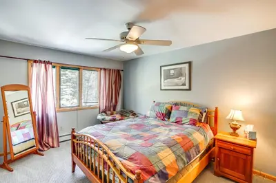 a bedroom with a bed and a ceiling fan at Less Than 1 Mi to Hunter Mtn Spacious Home with Hot Tub! in Lanesville
