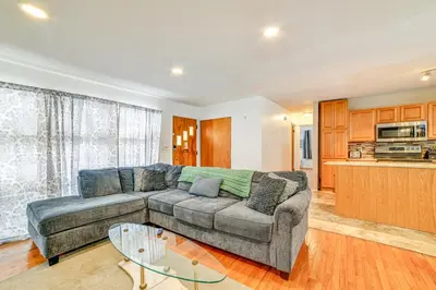 a living room with a couch and a table at 4 Mi to Dtwn Pet-Friendly Home in Utica in Utica