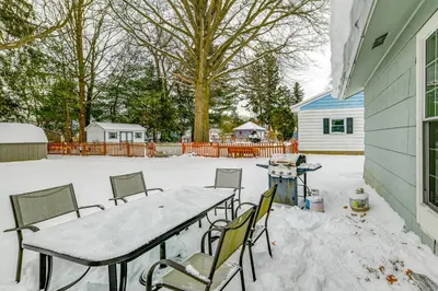 a patio with a table and chairs in the snow at 4 Mi to Dtwn Pet-Friendly Home in Utica in Utica