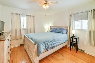 a bedroom with a bed and a ceiling fan at 4 Mi to Dtwn Pet-Friendly Home in Utica in Utica