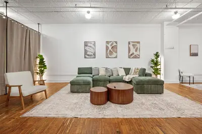 a living room with a couch and a table at Soho Fancy 4 Bedroom 2000 square feet Loft in New York