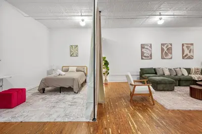 a living room with a bed and a couch at Soho Fancy 4 Bedroom 2000 square feet Loft in New York