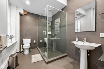 a bathroom with a shower and a toilet and a sink at Soho Fancy 4 Bedroom 2000 square feet Loft in New York
