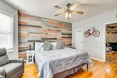 a bedroom with a bed and a brick wall at 1 Mi to Downtown Newark Urban Escape! in Newark