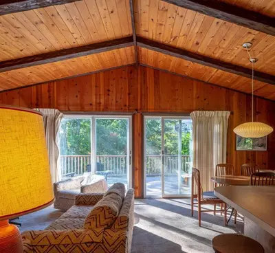a living room with a couch and a table at Retro Retreat Charming Home with Hot Tub & Fire Pit in Rensselaer