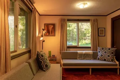 a living room with a couch and a window at Retro Retreat Charming Home with Hot Tub & Fire Pit in Rensselaer
