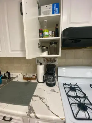 a kitchen counter with a sink and a stove at Entire House in West Ny, NJ12 mints from NYCity Time Square in West New York