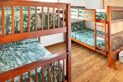 a room with two bunk beds and a couch at Spacious 3BR House, Hot Tub, Firepit, Ski Access! in Emerald Lakes