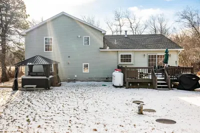a house with a snow covered yard in front of it at Spacious 3BR House, Hot Tub, Firepit, Ski Access! in Emerald Lakes