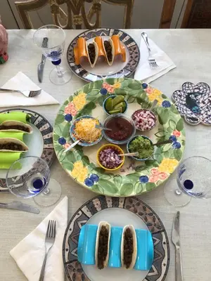 a table with plates of food on a table at Spacious Room with a View of the Woods in Armonk