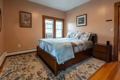 a bedroom with a bed and a window at Beechmont-Charming Colonial for Events and Getaways! in Bridgeport