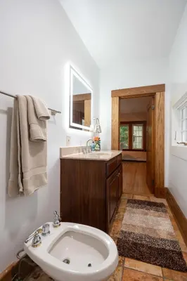 a white bathroom with a sink and a tub at Beechmont-Charming Colonial for Events and Getaways! in Bridgeport