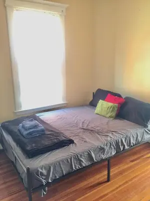 a large bed in a room with a window at SouthGreen APT 2S in Hartford