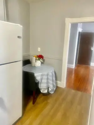 a kitchen with a table and a refrigerator at SouthGreen APT 2S in Hartford