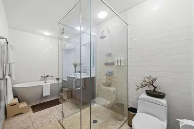 a bathroom with a shower and a toilet and a sink at Broadway Terrace by Rove Loft with Private Terrace in New York