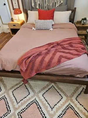 a bed with a pink blanket on top of it at New- Farm view-Winter escape with cozy fireplace in Lake Katrine