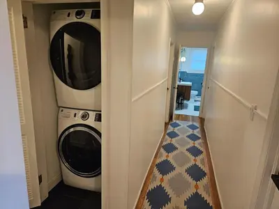 a laundry room with a washing machine and a washer and dryer at New- Farm view-Winter escape with cozy fireplace in Lake Katrine