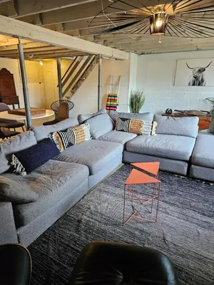 a living room with a couch and a table at New- Farm view-Winter escape with cozy fireplace in Lake Katrine