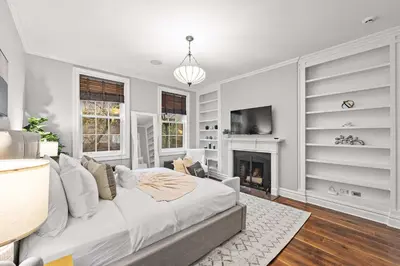a bedroom with a bed and a fireplace at Downing by Rove Travel Private Terrace & Patio in New York