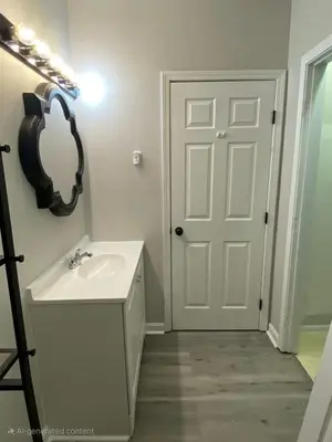 a white bathroom with a sink and a mirror at Private Apartment in Southbury 103 in Southbury