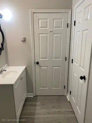 a bathroom with a white door and a sink at Private Apartment in Southbury 103 in Southbury