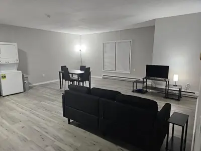 a living room with a couch and a table at Private Apartment in Southbury 103 in Southbury
