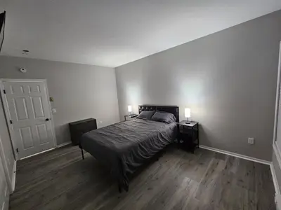 a bedroom with a bed with two night stands and two lamps at Private Apartment in Southbury 103 in Southbury