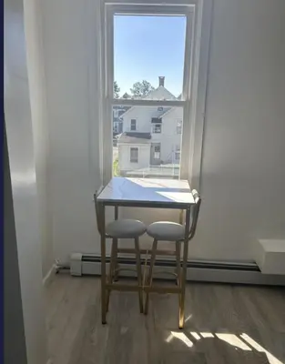a table and two chairs in front of a window at Keri APRN LLC in Ansonia