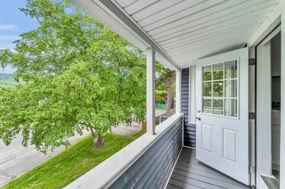 a porch with a white door and a window at Pitcher's Paradise Apt 3 All Star Baseball Rentals in Oneonta