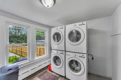a laundry room with two washers and a window at Pitcher's Paradise Apt 3 All Star Baseball Rentals in Oneonta