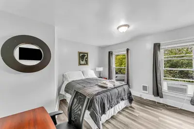 a white bedroom with a bed and a window at Pitcher's Paradise Apt 3 All Star Baseball Rentals in Oneonta