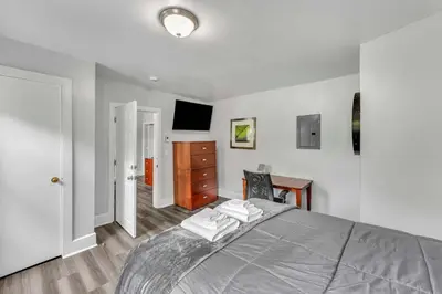 a bedroom with a bed with a dresser and a desk at Pitcher's Paradise Apt 3 All Star Baseball Rentals in Oneonta